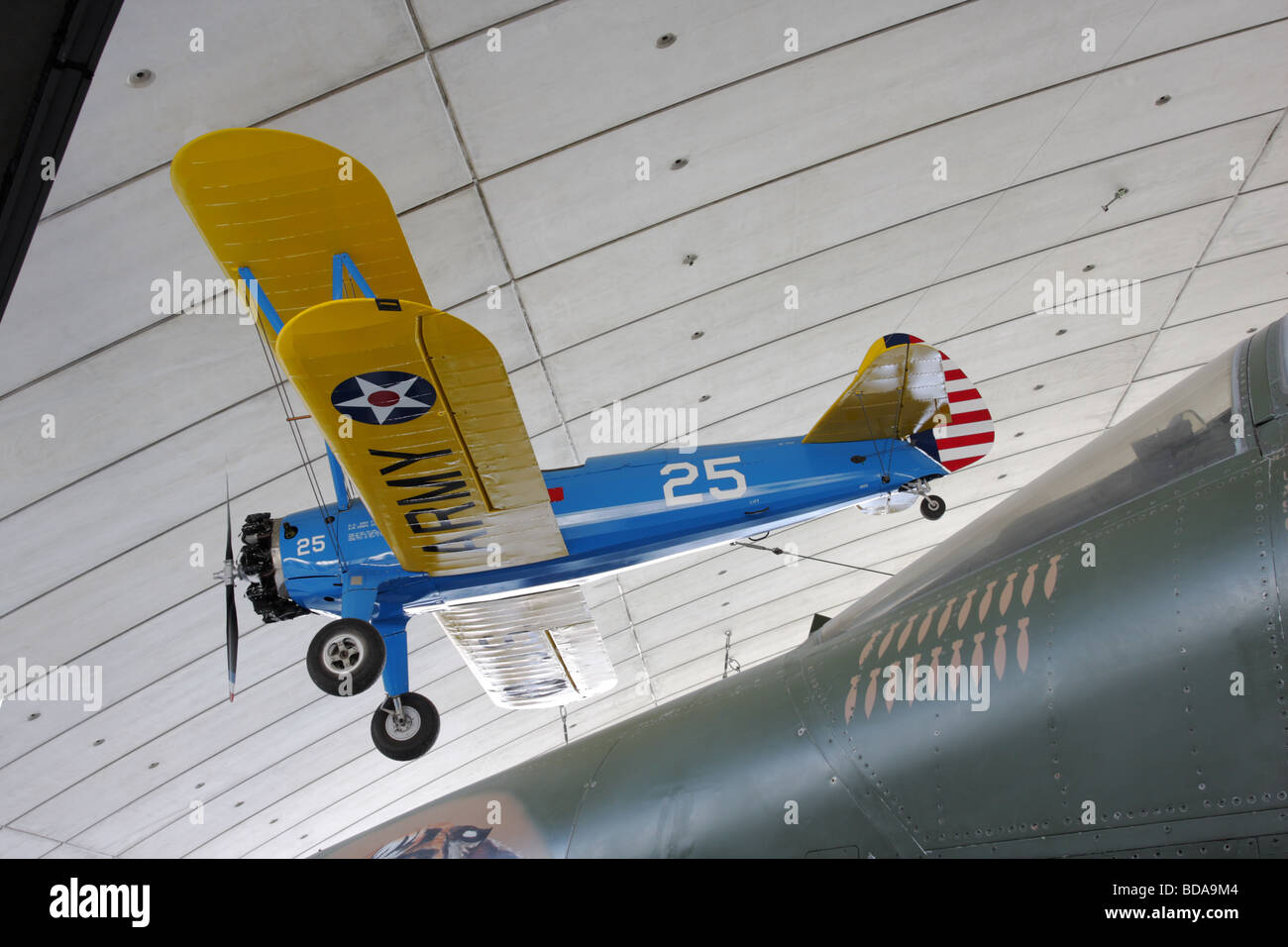In blue and yellow livery the Stearman PT-17 Kaydet and the cockpit of the General Dynamics F-111E multi-role jet fighter. Stock Photo