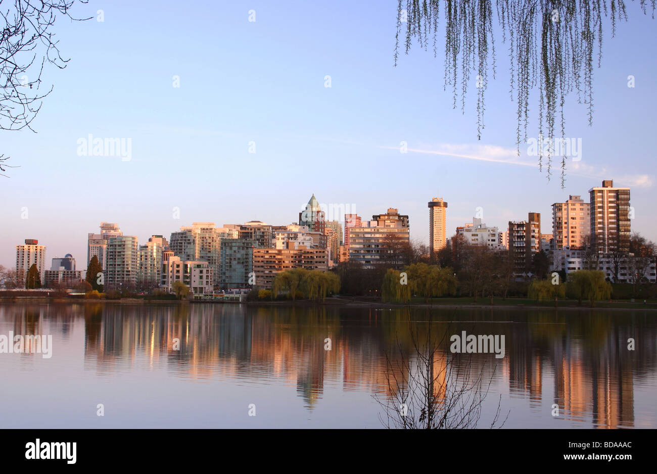 Vancouvers west end reflected in Lost Lagoon - Stanley Park Stock Photo