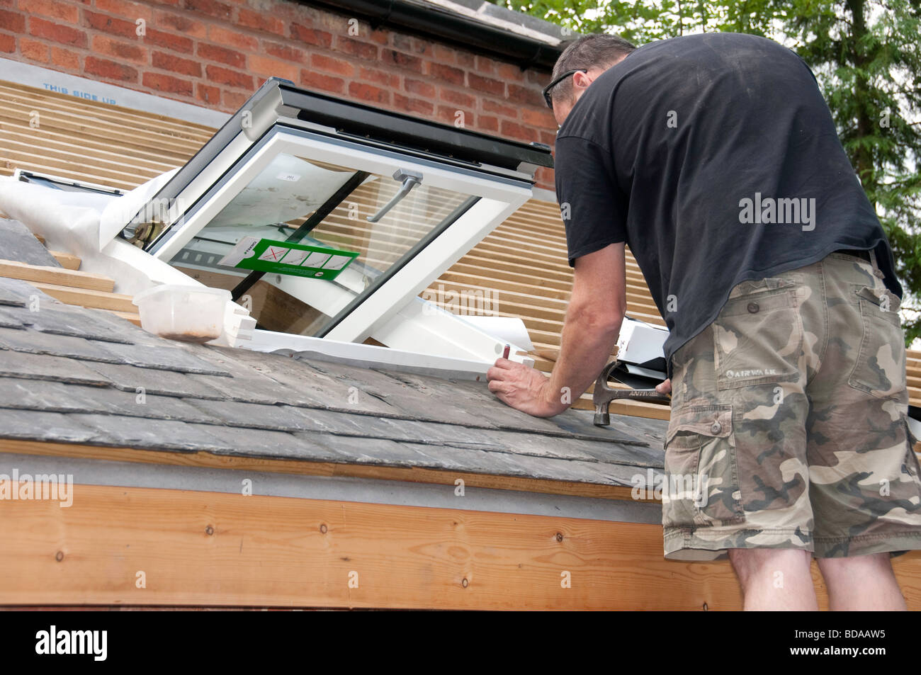Reclaimed roofing tiles being used on cottage renovation project with