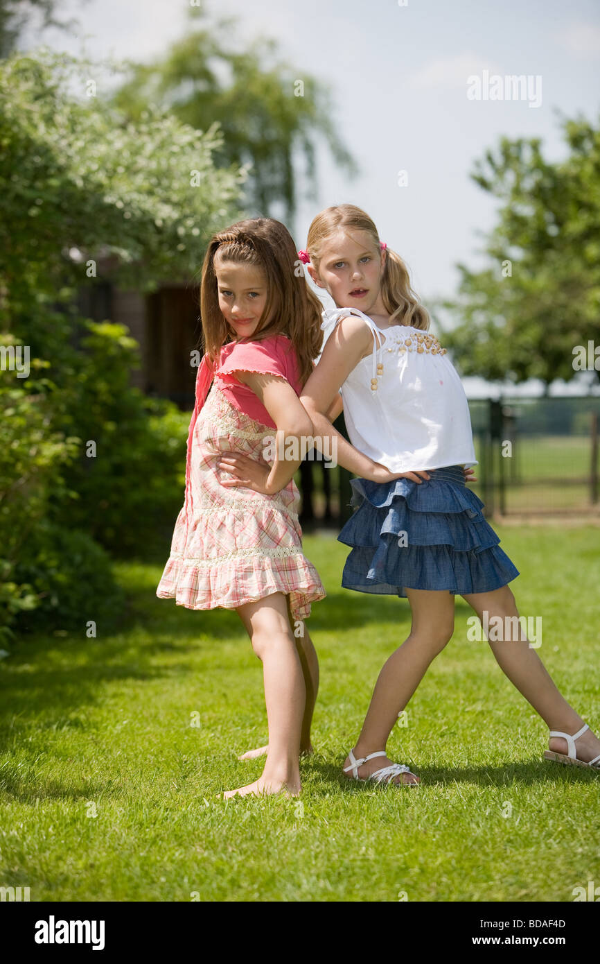 Two young girls having fun posing as real models Stock Photo