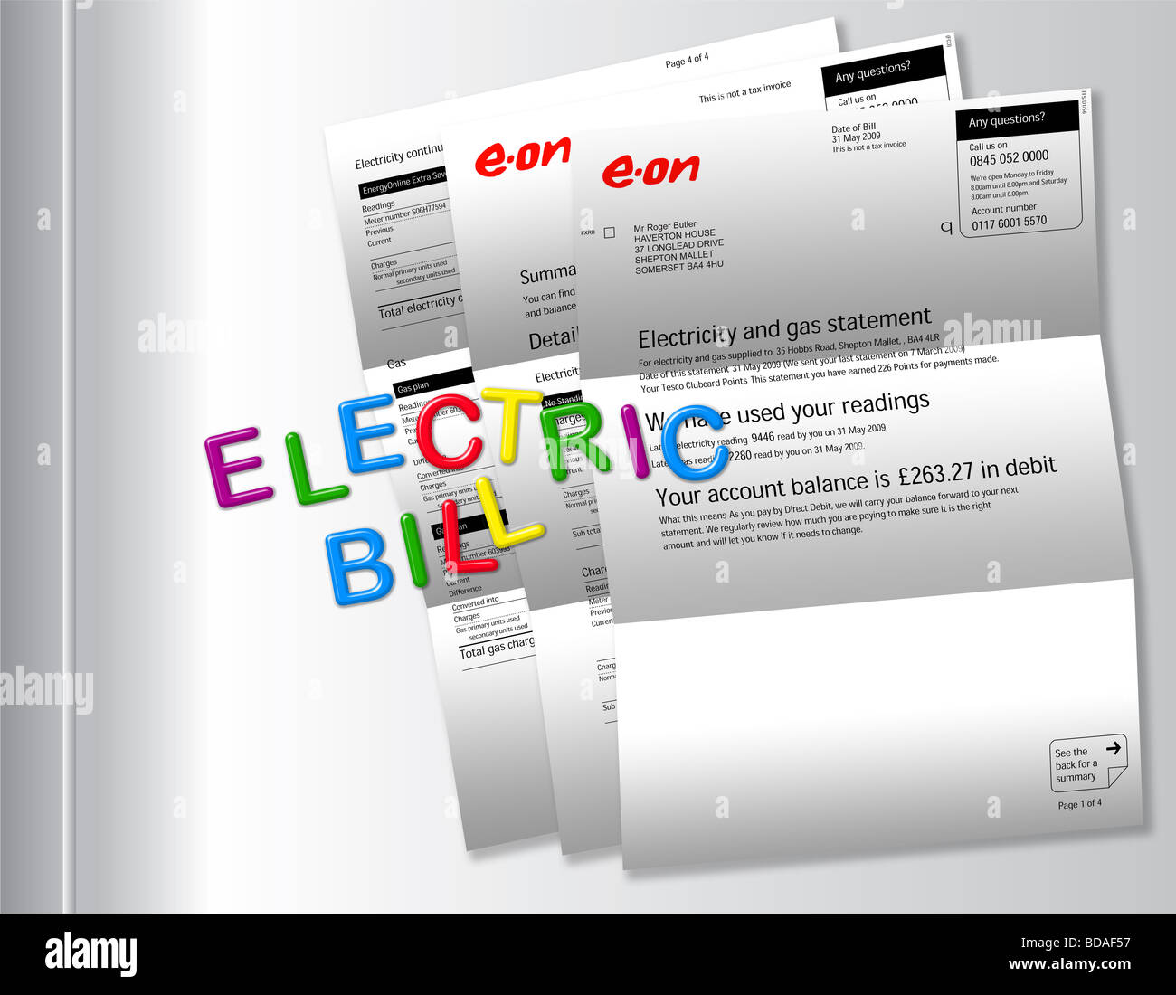 Electric bills on fridge with ‘ELECTRIC BILL’ spelt out by magnetic fridge letters. Stock Photo