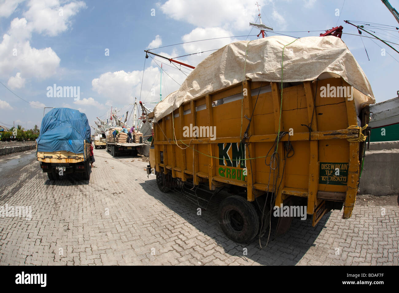 Indonesia Java Jakarta old Batavia Sunda Kelapa lorries loaded with cement bags waiting for unloading Stock Photo