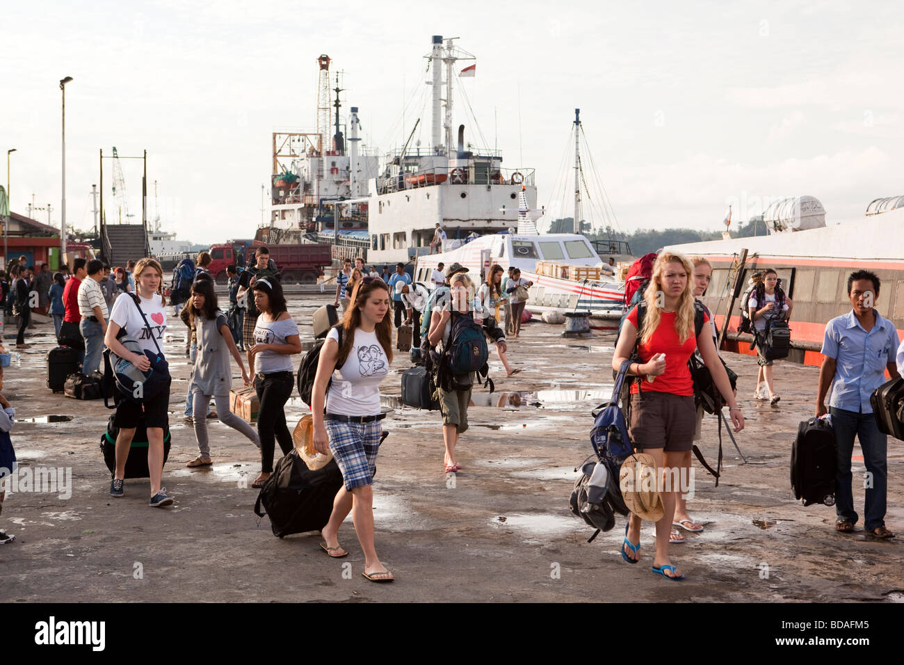 Indonesia Sulawesi Kendari western college students on quayside to board coastal ferry boat Stock Photo