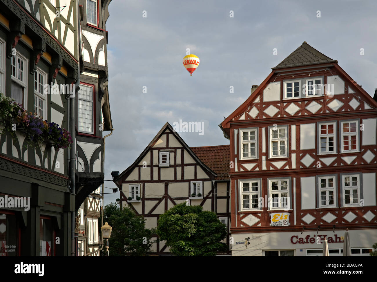 Hot air balloon above medieval town of Fritzlar, Hesse, Germany. Stock Photo