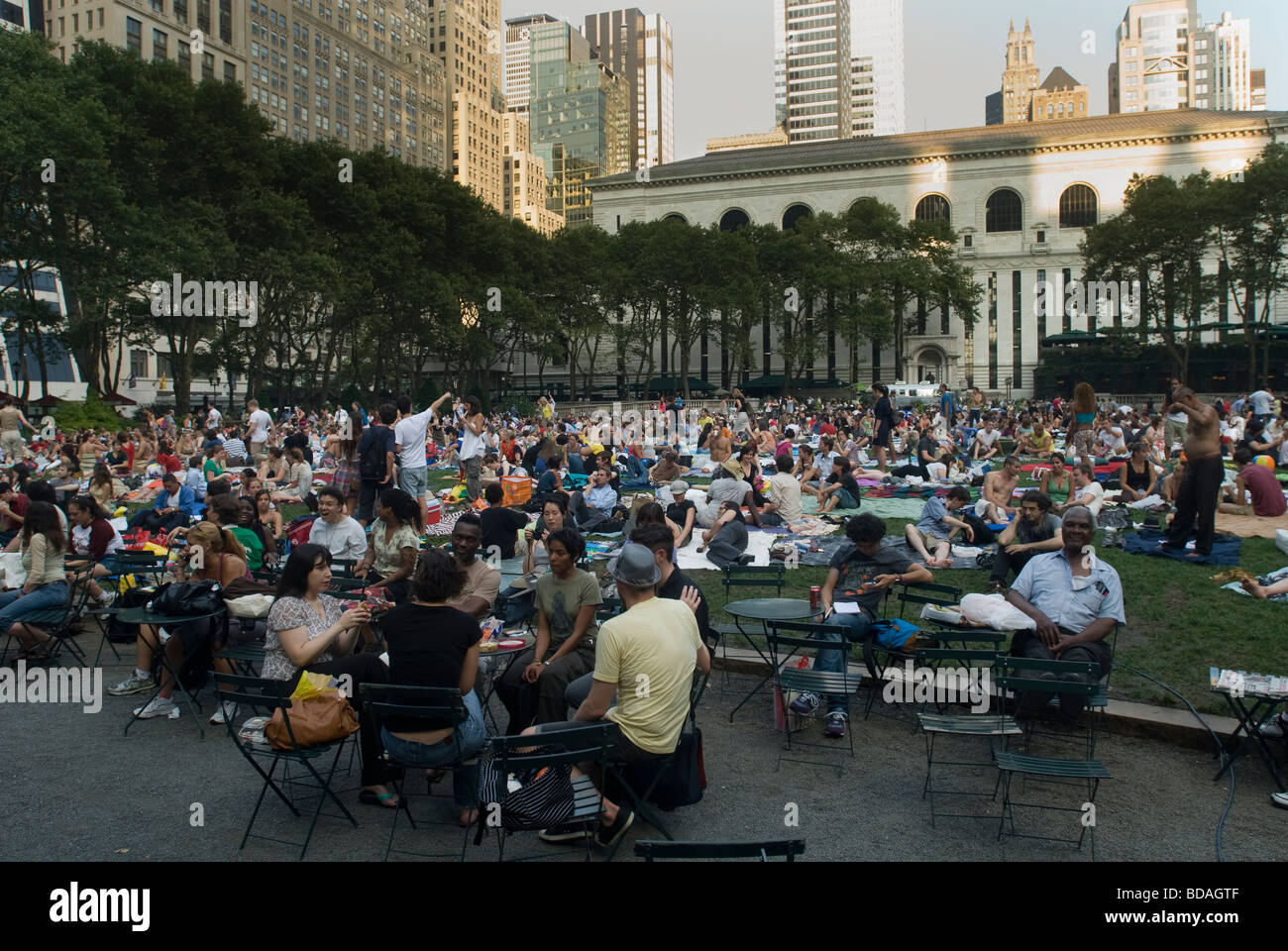 Thousands of people spread their blankets and claim their chairs in Bryant Park in New York on Monday free movie night Stock Photo