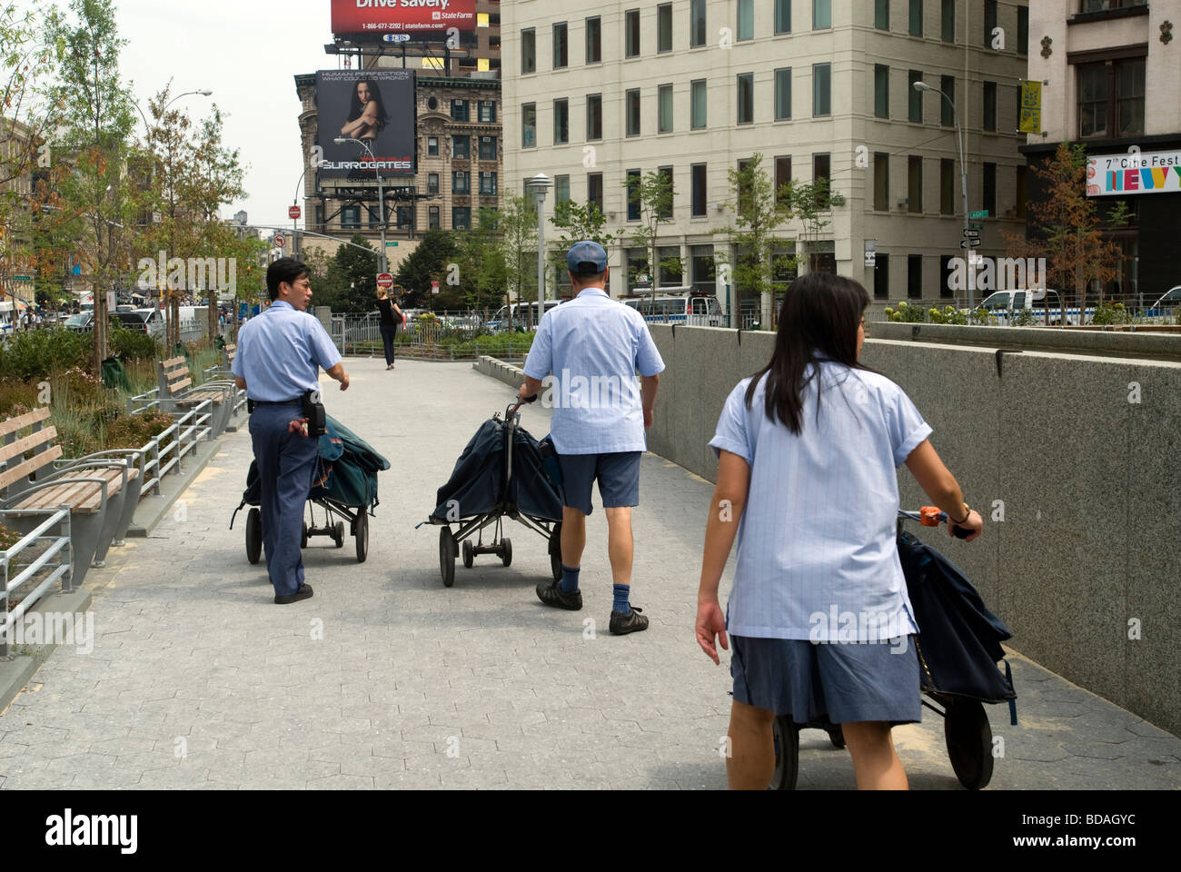 USPS mail carriers walk through CaVaLa Park in the New York neighborhood of Tribeca Stock Photo