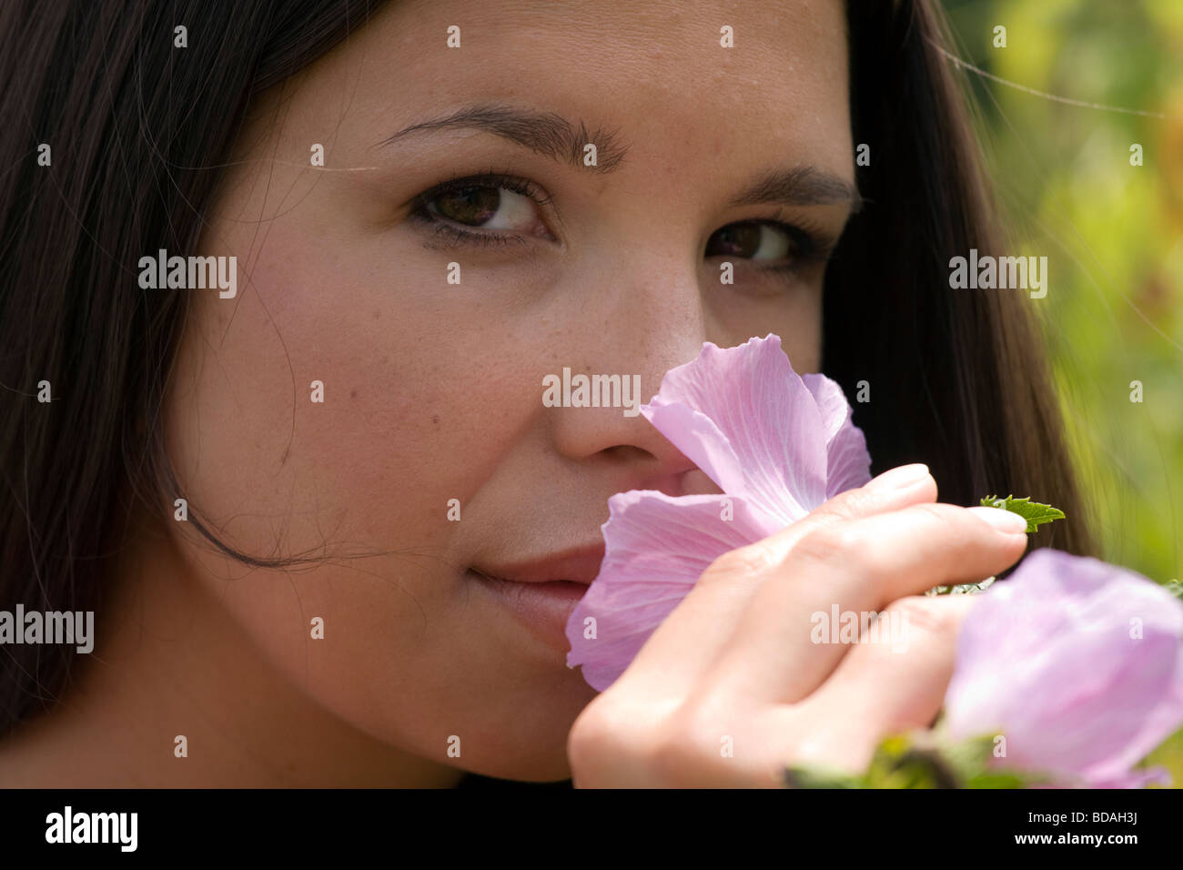 Beutiful girl smelling the flowers in the garden Stock Photo Alamy