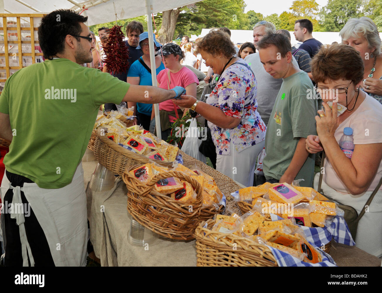 Stallholder selling cheese. West Dean Chilli Fiesta, West Sussex, England, UK. Stock Photo
