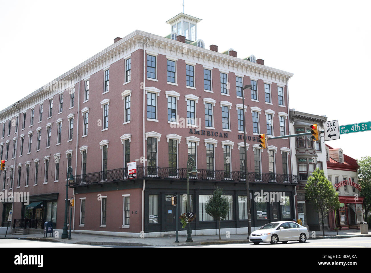 Large square commercial Style brick building with wide decorative