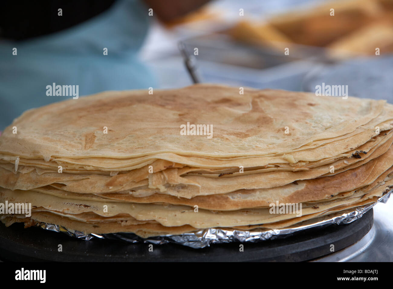 pile of crepes warming on a food stall at an outdoor food market in the uk Stock Photo