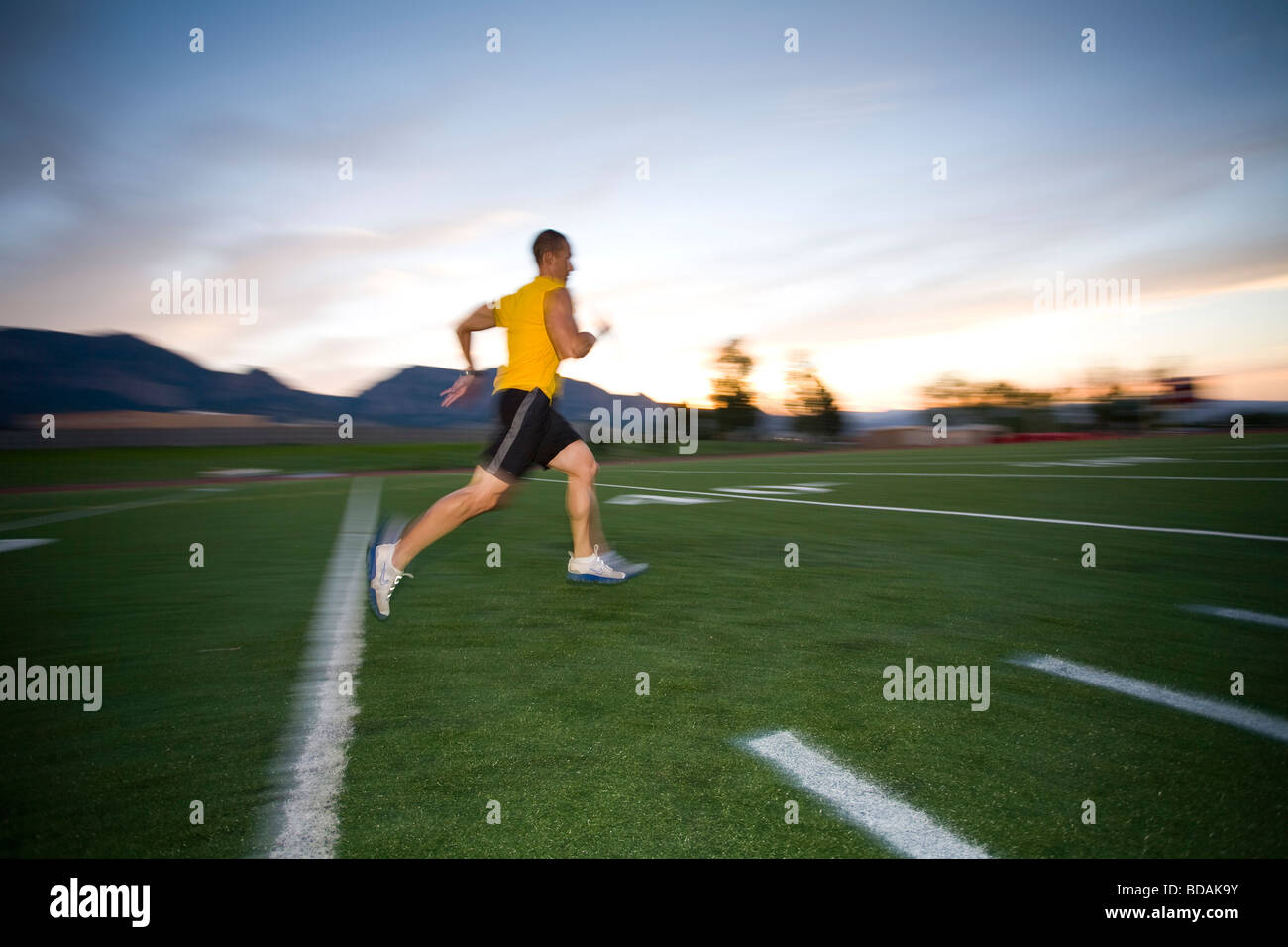 Athletes training by running and sprinting on a track field in Boulder
