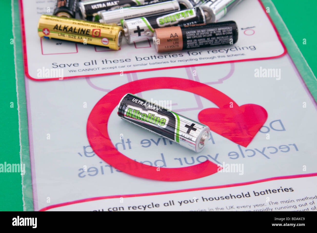 Used household batteries and battery recycling bag with logo. England UK Britain Stock Photo