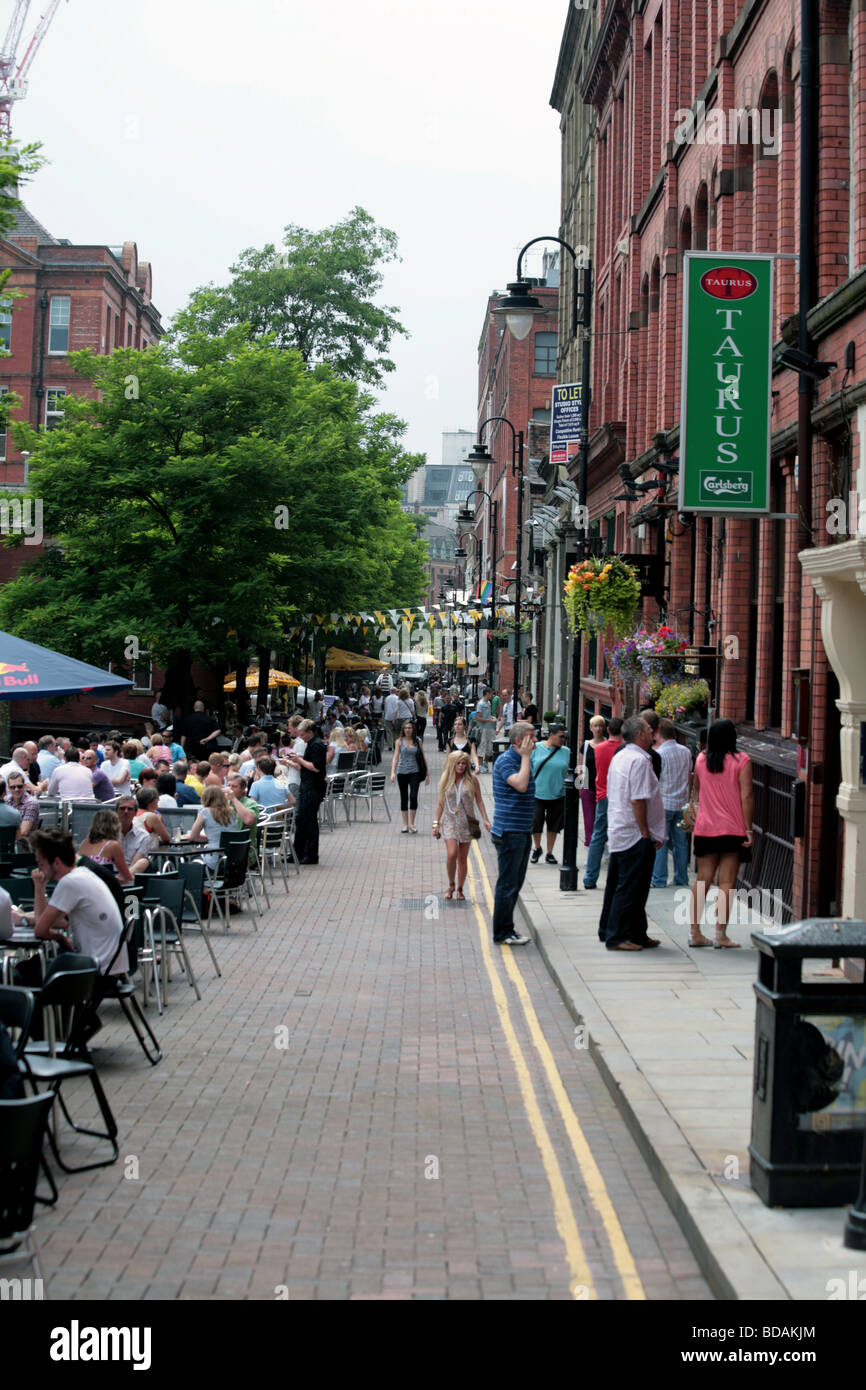 People relaxing outside restaurants and bars Canal Street Manchester England Stock Photo