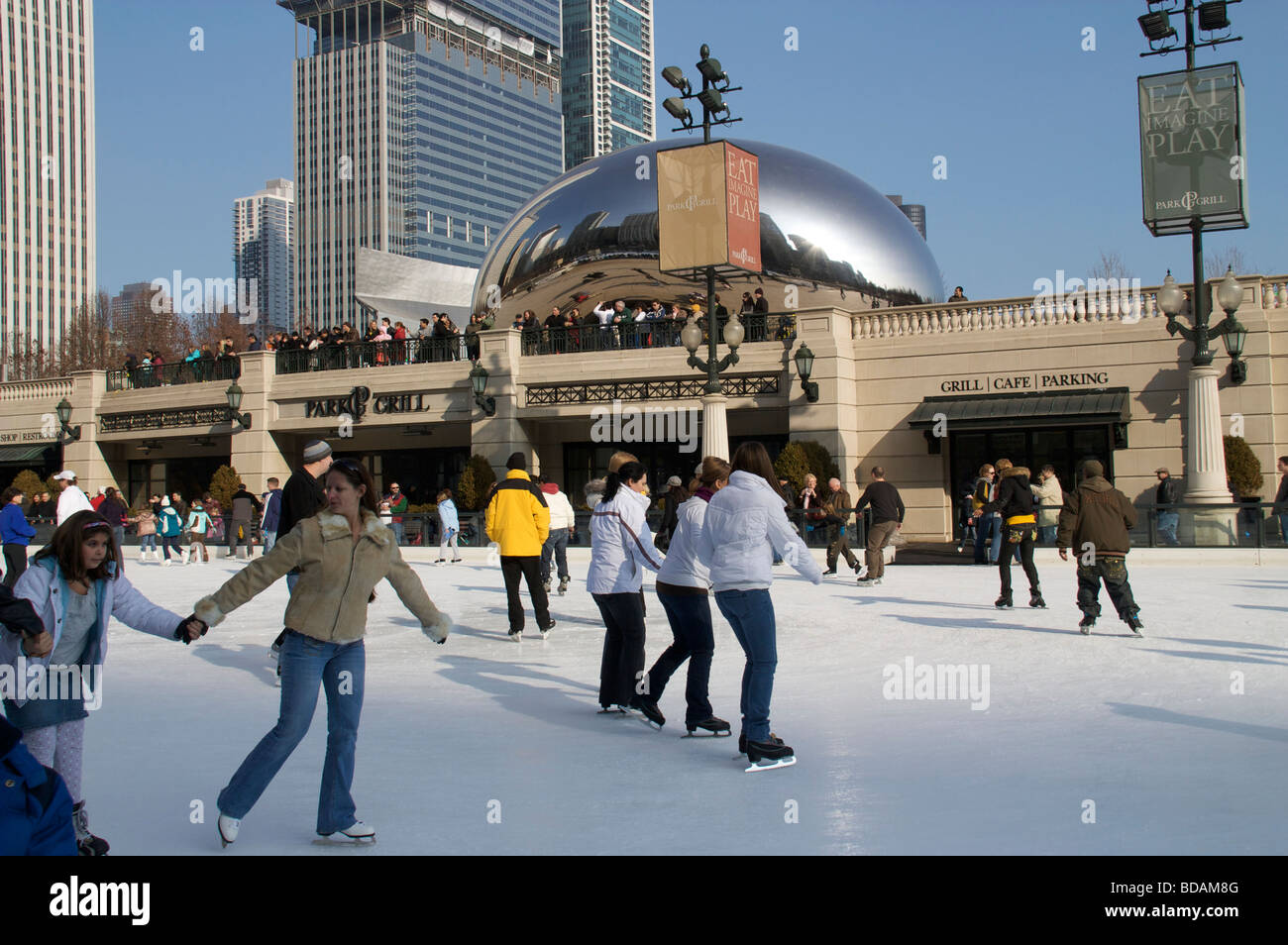 McCormick Tribune Ice Rink Millennium Park with skaters. Chicago