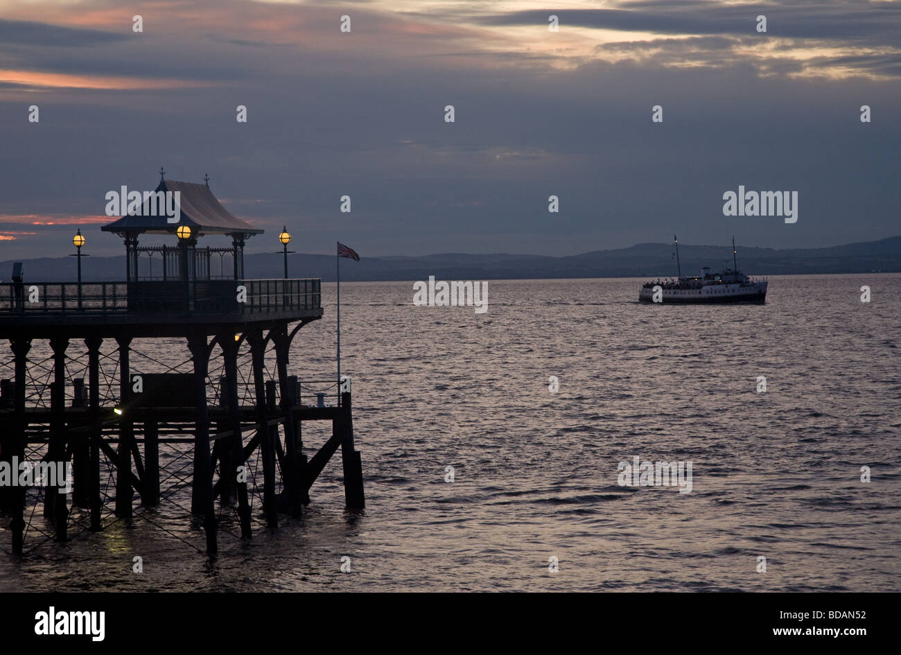 Clevedon Pier at sunset with the Balmoral steam ship preparing to dock, Clevedon, North Somerset, England, UK Stock Photo