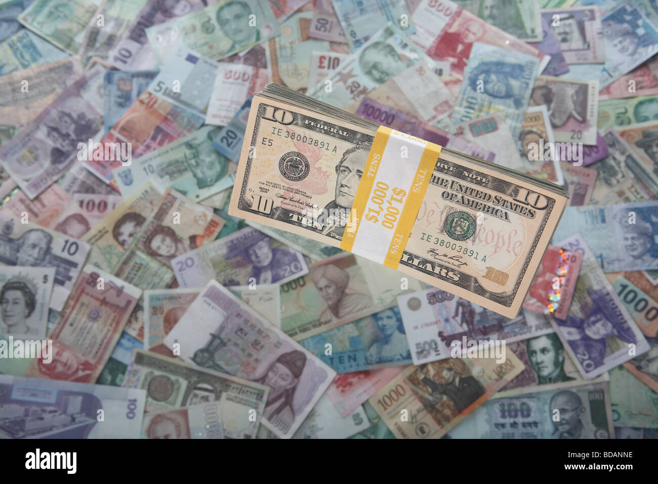 A bundled stack of ten dollar bills on a soft background of international currencies Stock Photo