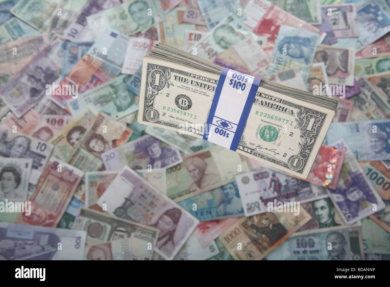 A bundled stack of one dollar bills on a soft background of international currencies Stock Photo