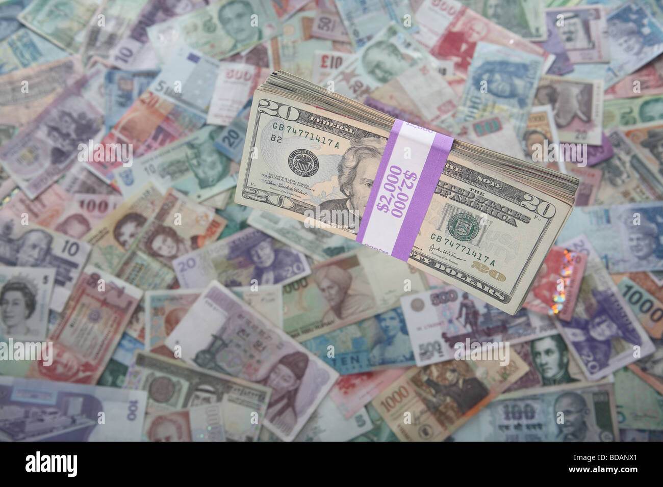 A bundled stack of twenty dollar bills on a soft background of