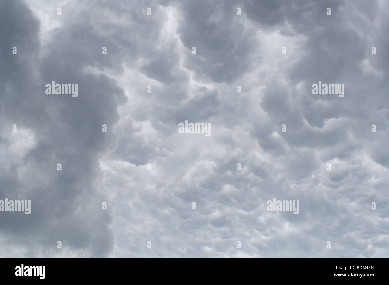 Very dense grey clouds before a storm. Stock Photo