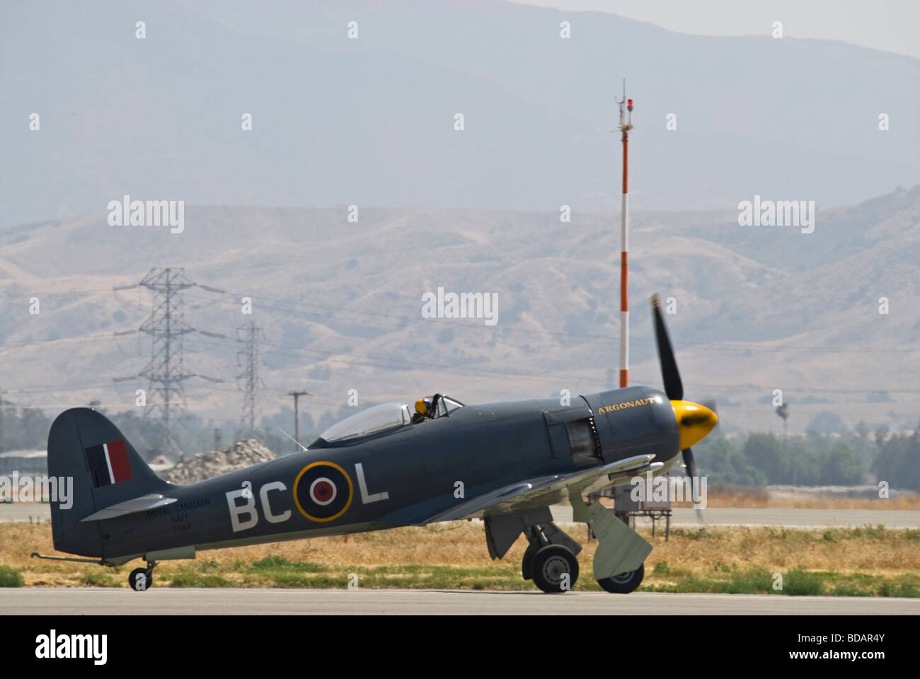 A Hawker Sea Fury taxis on the runway after flying at an air show. Stock Photo