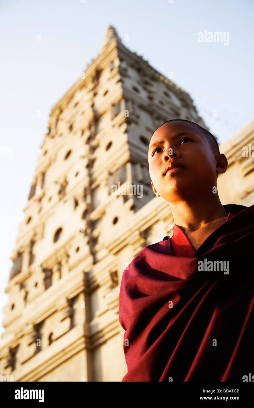 Monk day dreaming in front of a temple, Mahabodhi Temple, Bodhgaya ...