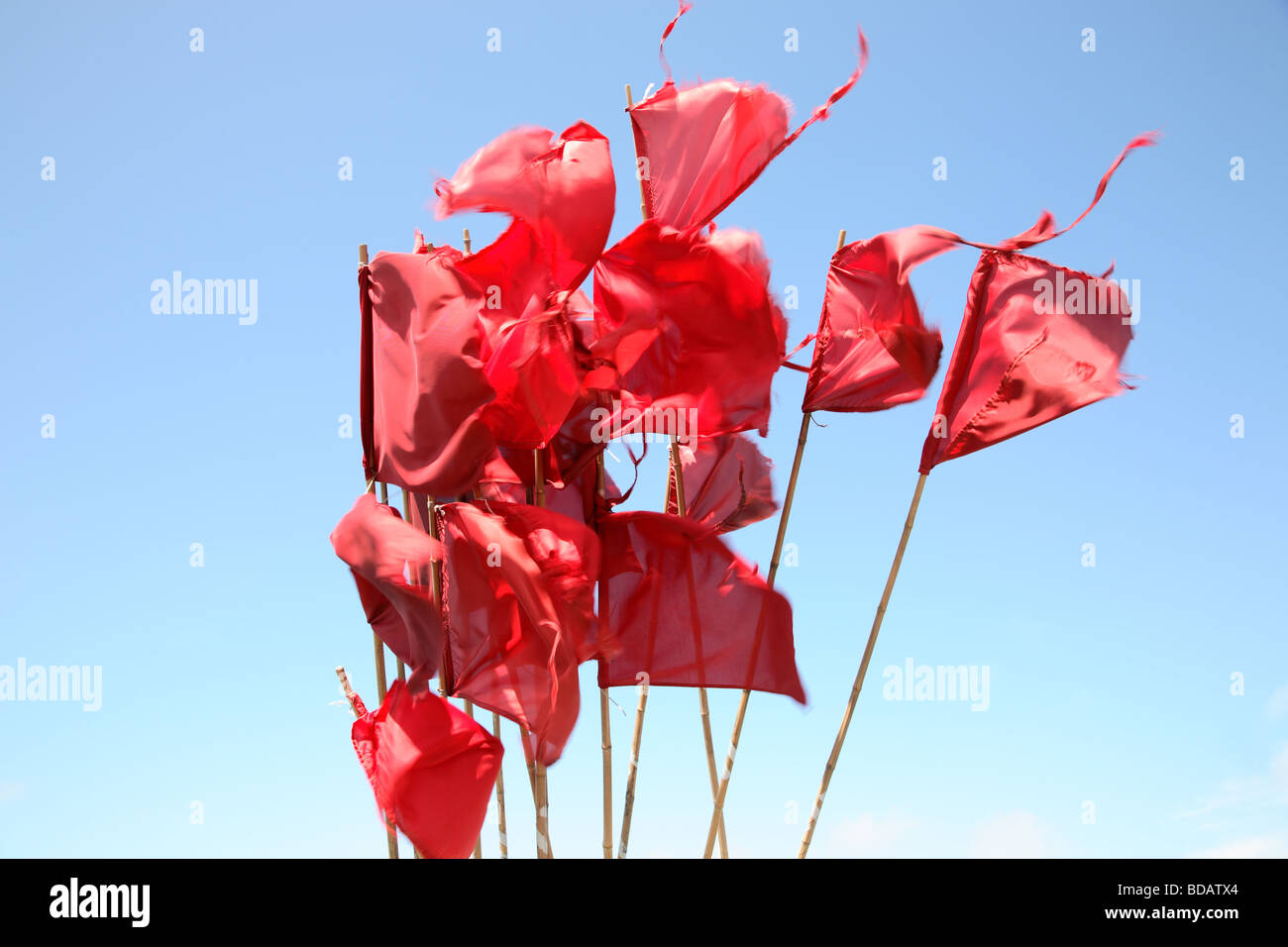 Red fishing buoy flags against a blue summer sky in a Danish harbour Stock Photo