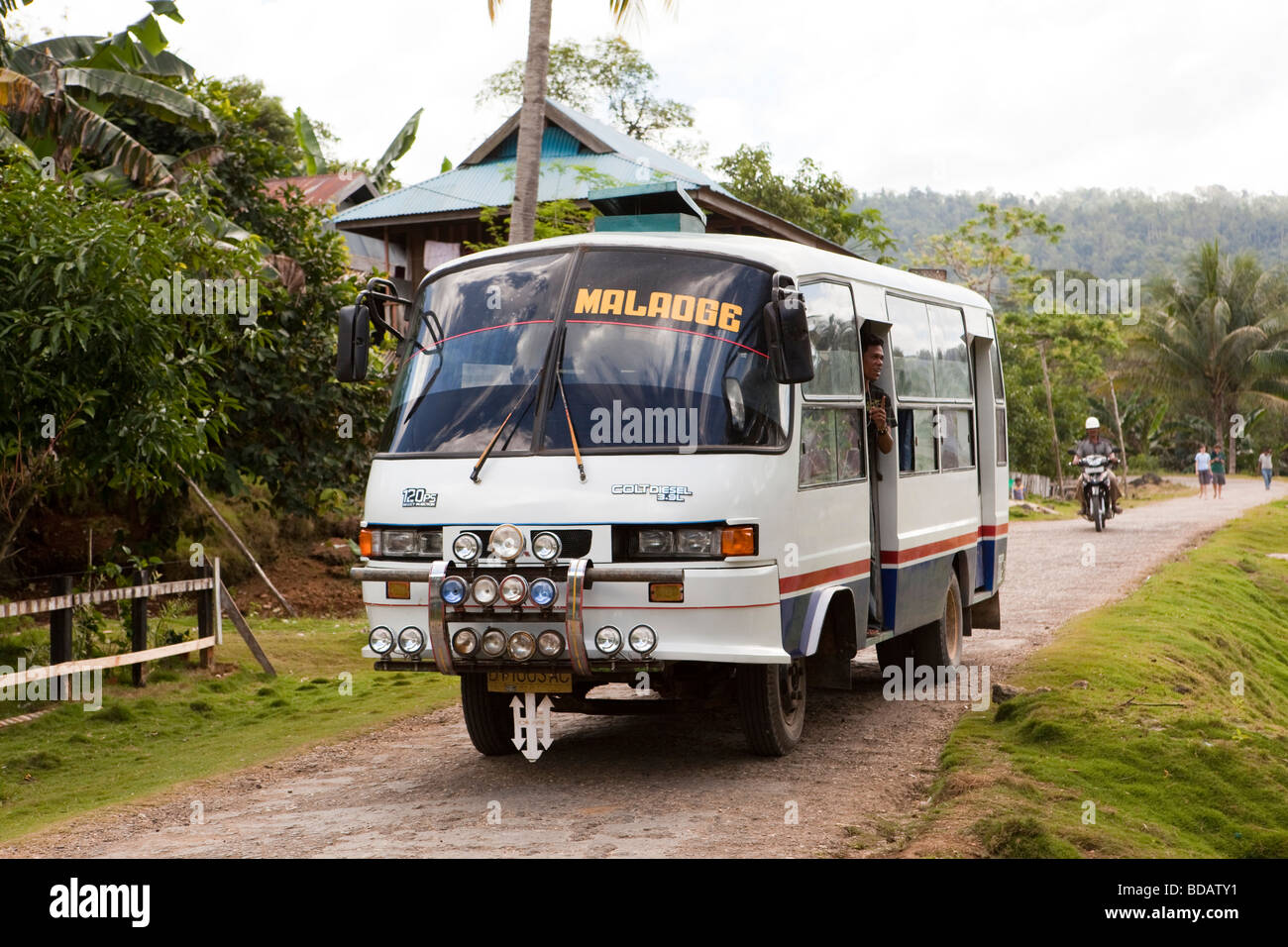 Indonesia Sulawesi Buton Labundo Bundo local transport bus passing through village Stock Photo