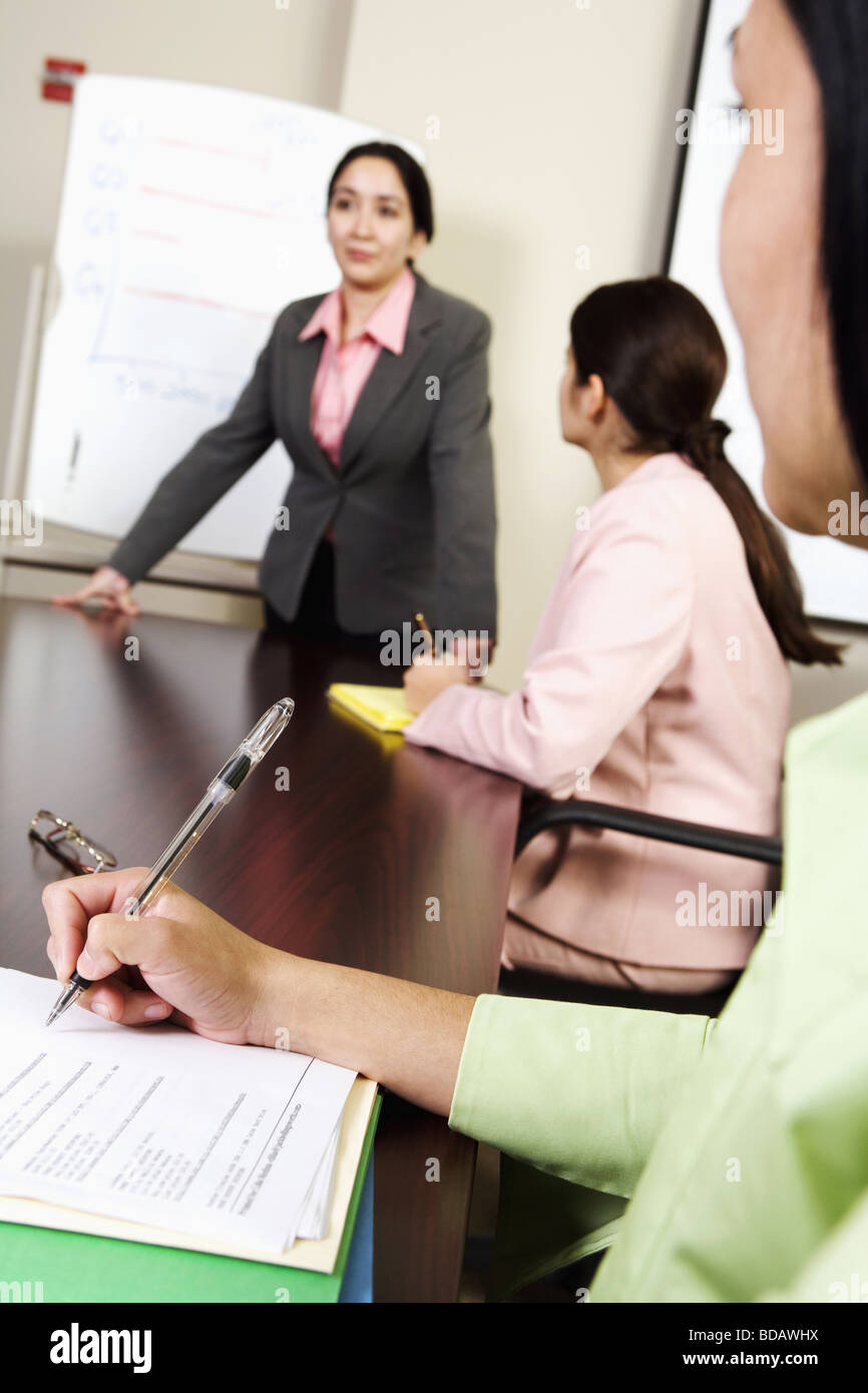 Three businesswomen at a meeting in a conference room Stock Photo