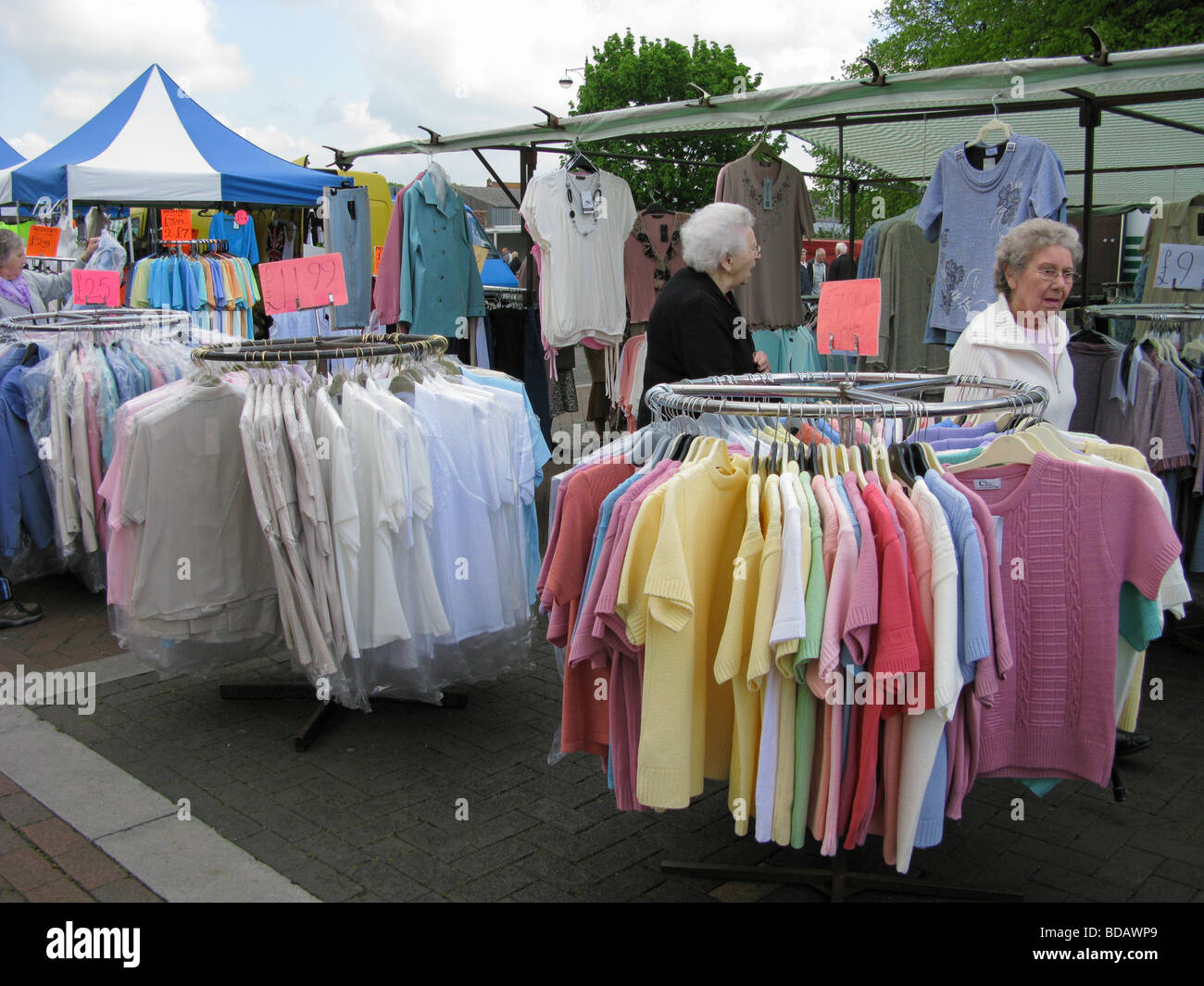 elderly people shopping at a bargain clothes stall Chichester