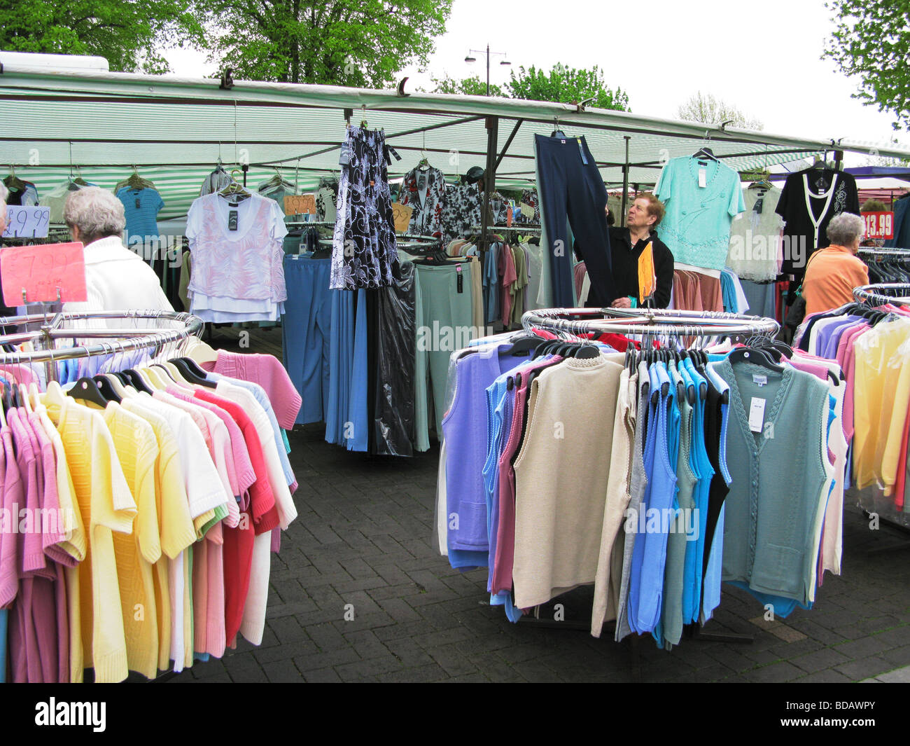 elderly people shopping at a bargain clothes stall Chichester