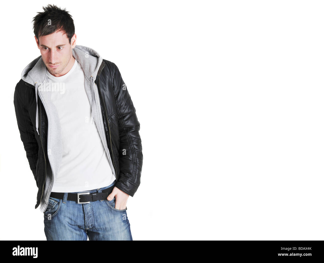 Young white man in leather jacket, jeans and white t-shirt looking off  camera Stock Photo - Alamy