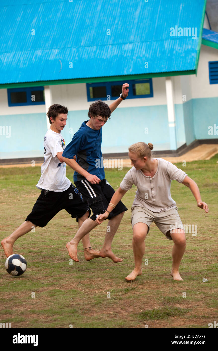 Indonesia Sulawesi Buton Labundo Bundo Operation Wallacea volunteers playing football on school pitch Stock Photo