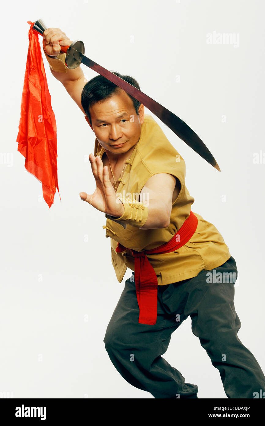 Close-up of a mature man practicing martial arts with a sword Stock Photo