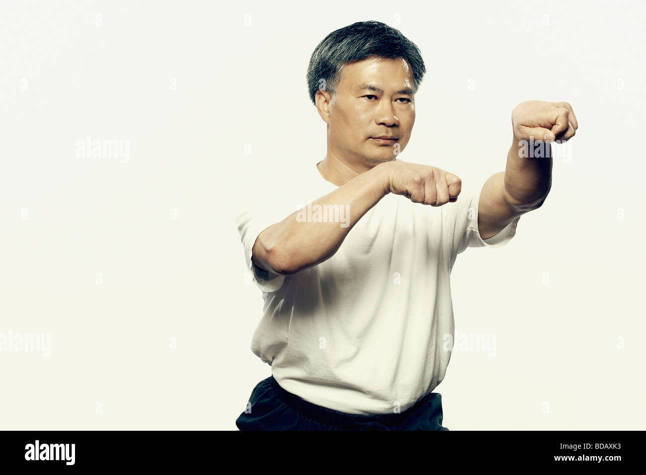 Mature man practicing martial arts Stock Photo