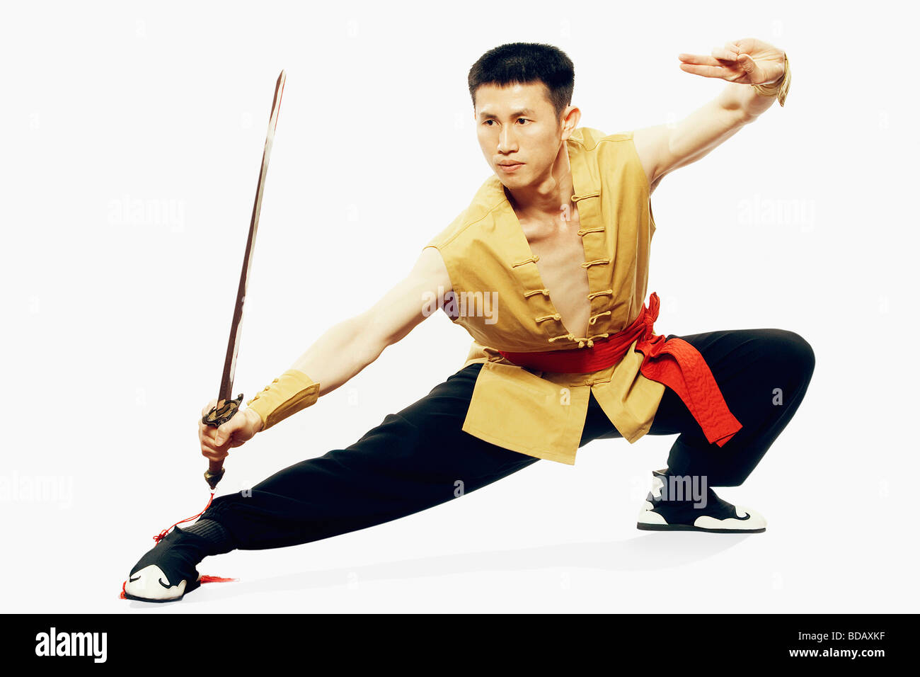 Mid adult man practicing martial arts with a sword Stock Photo