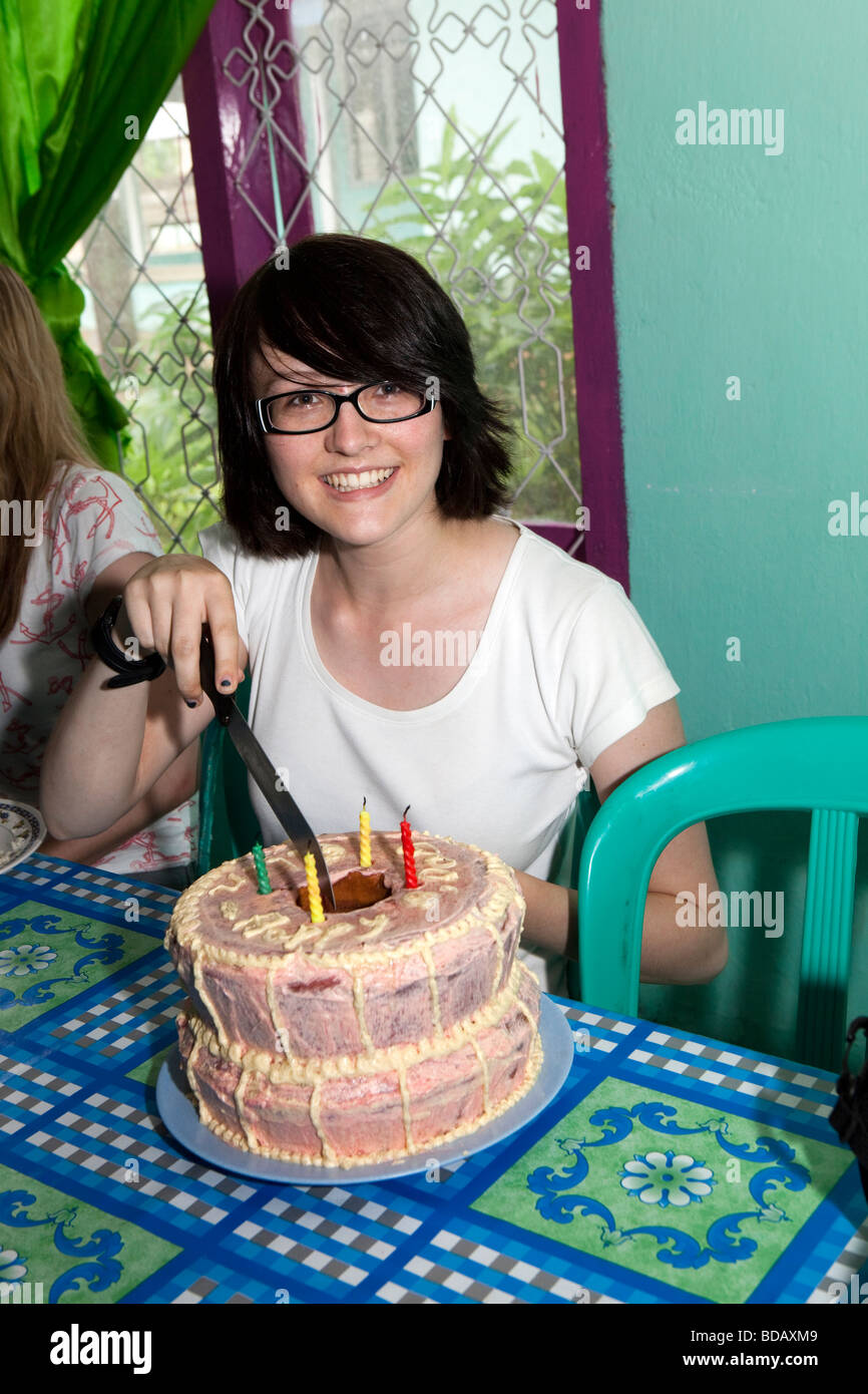 Indonesia Sulawesi Labundo Bundo Operation Wallacea volunteer cutting 18th birthday cake Stock Photo