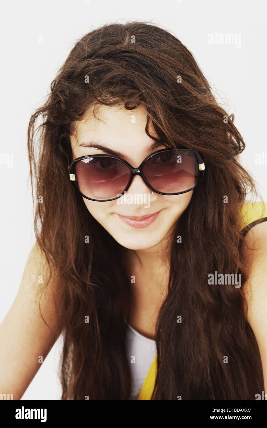 Portrait of a young woman wearing sunglasses and smiling Stock Photo ...