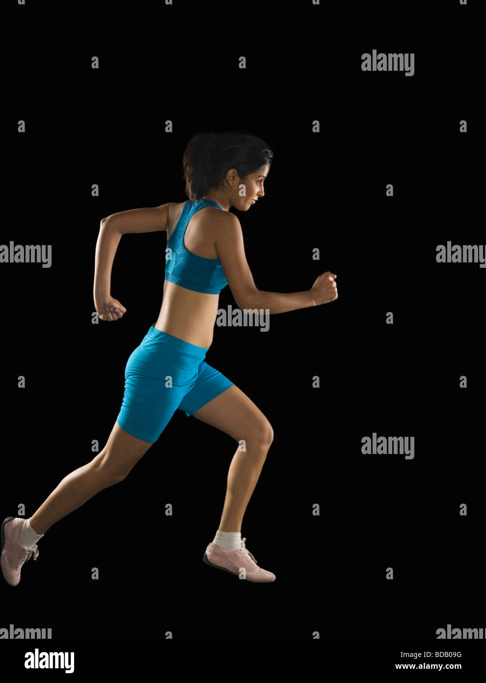Side profile of a young woman running Stock Photo - Alamy
