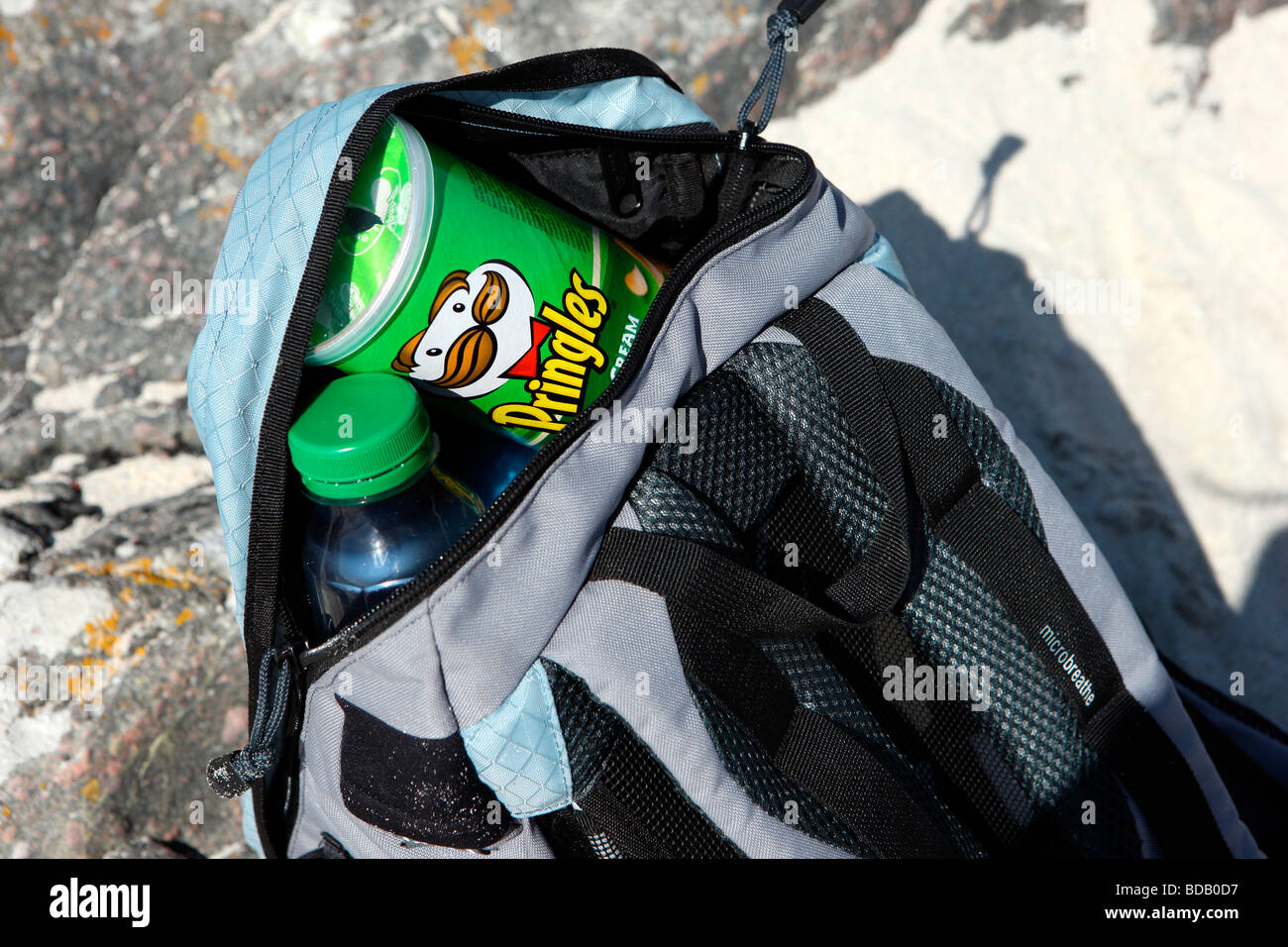 Pringles and a bottle in the top of a rucksack Stock Photo