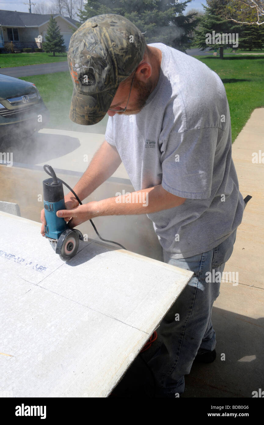 Carpenter using power cutting tool in construction project Stock Photo ...