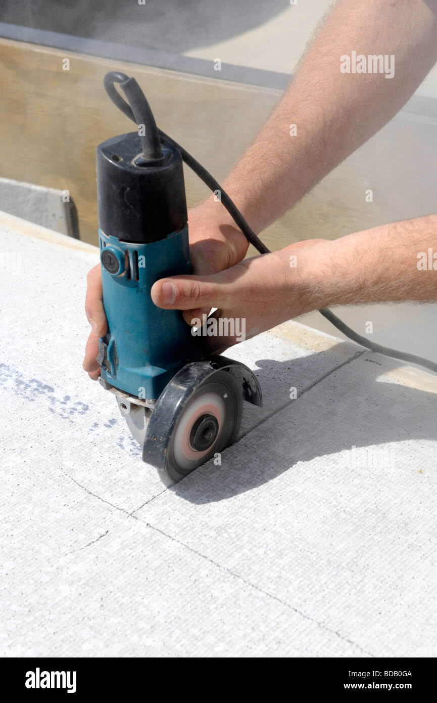 Carpenter using power cutting tool in construction project Stock Photo ...