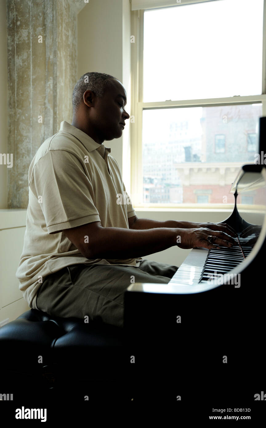 Man playing piano african american hi-res stock photography and images