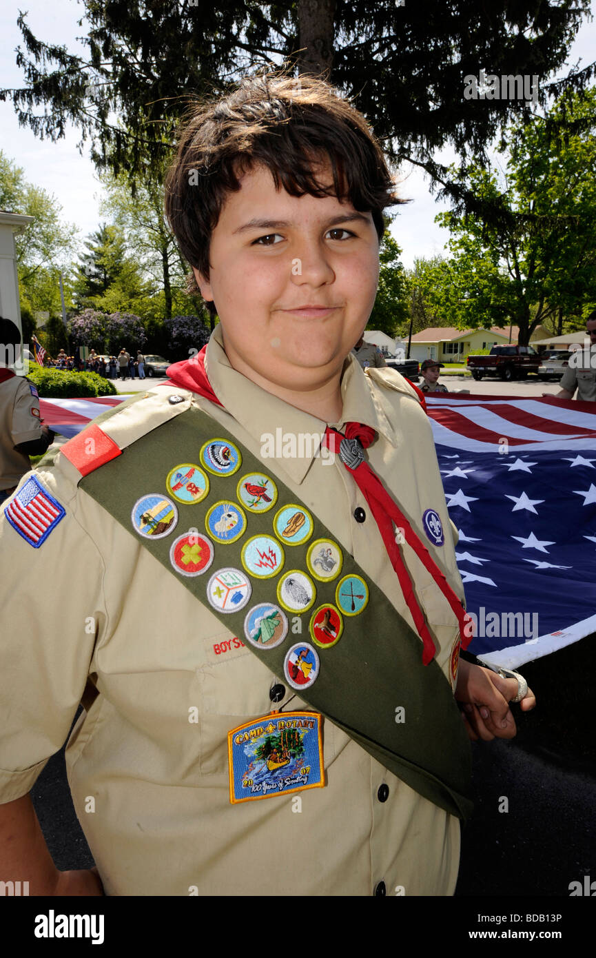 Boy scout in uniform displaying merit badges Stock Photo Alamy
