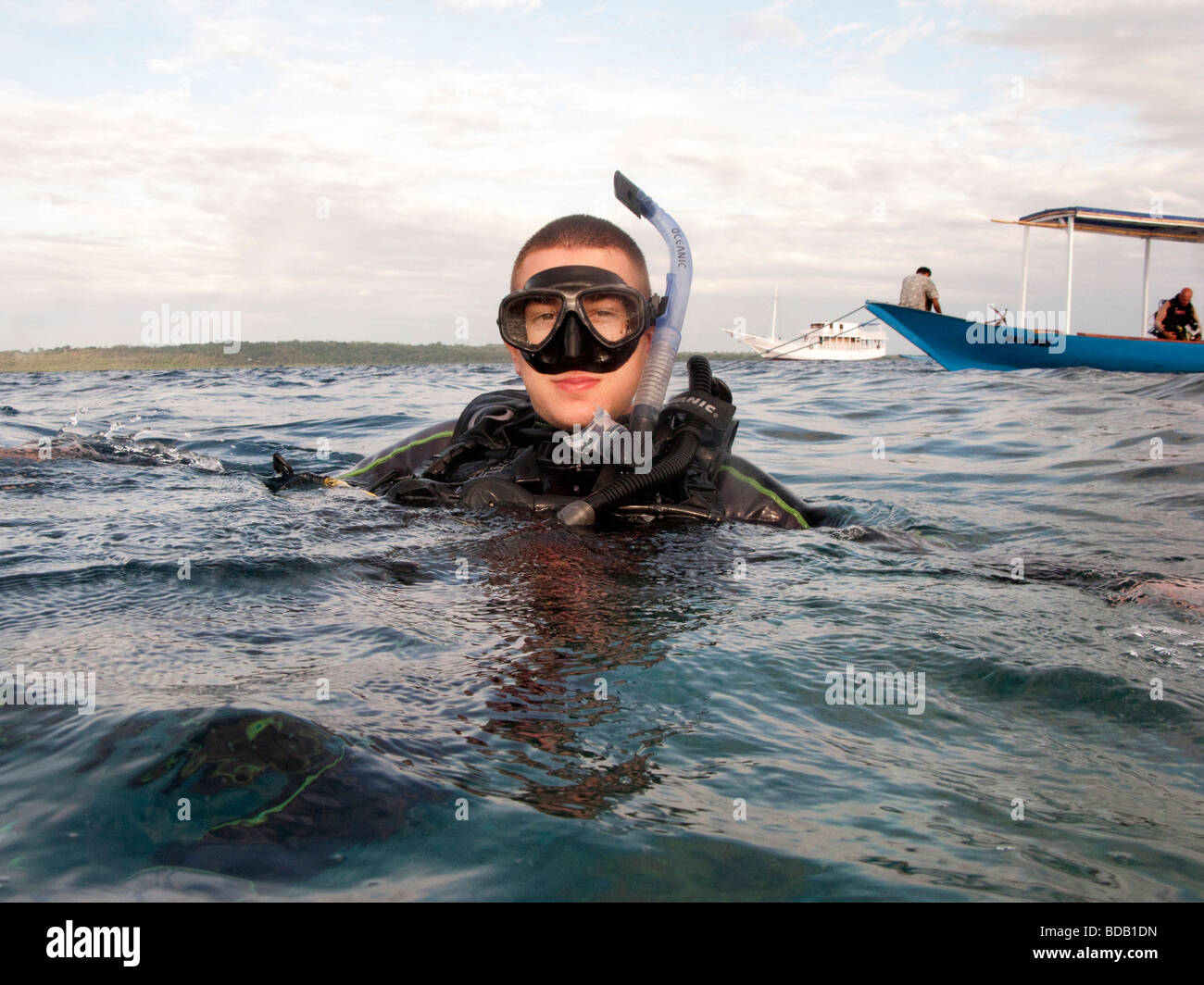 Indonesia Sulawesi Hoga Island Operation Wallacea diver on surface of water at dive boat Stock Photo