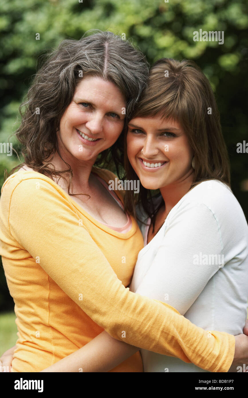 Portrait of a mature woman smiling in a park with her daughter Stock Photo