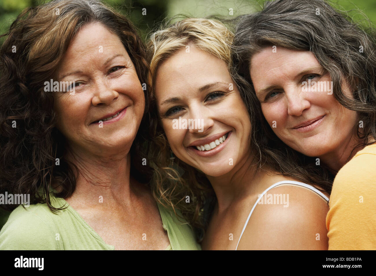 Portrait of two mature women smiling with a young woman Stock Photo