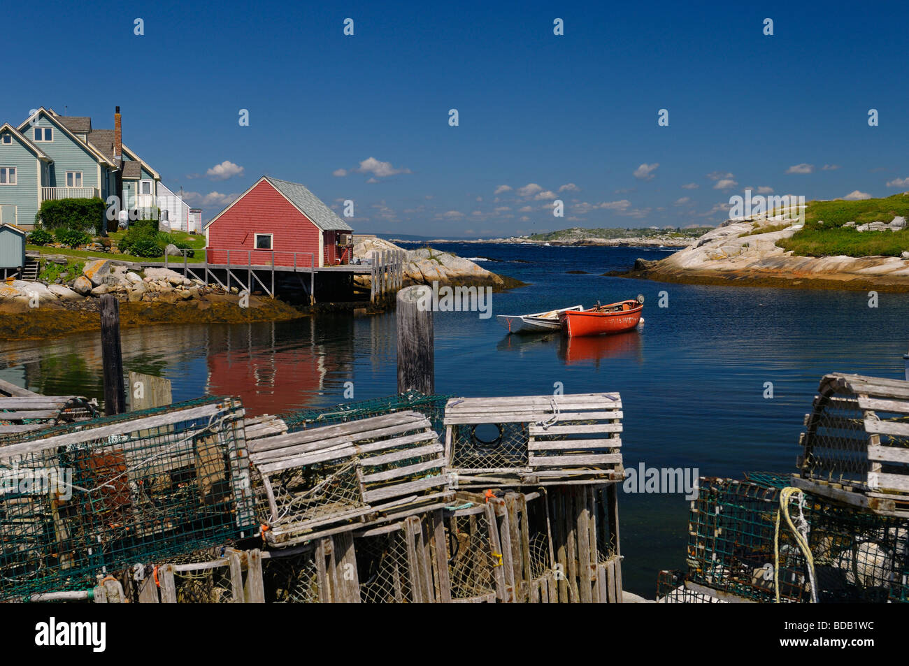 Lobster traps on the wharf in an inlet to the quiet fishing village of Peggy's Cove Nova Scotia Stock Photo