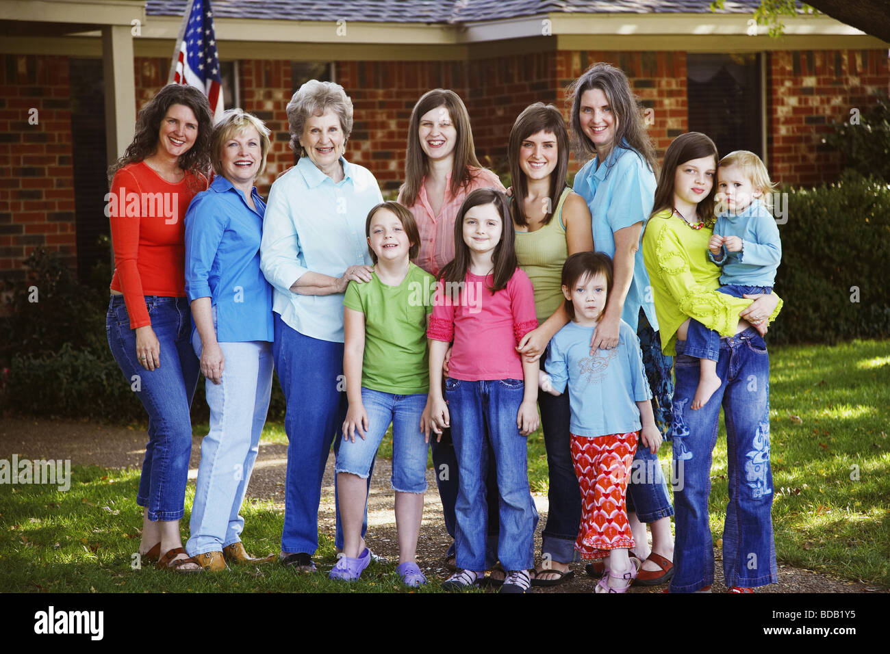 Portrait of a family standing in front of a house Stock Photo - Alamy