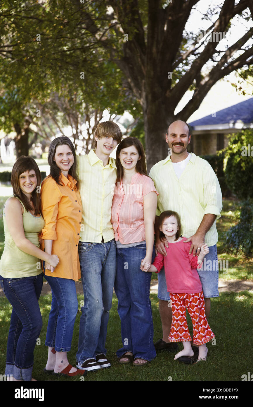 Portrait of a family standing together in a garden Stock Photo - Alamy