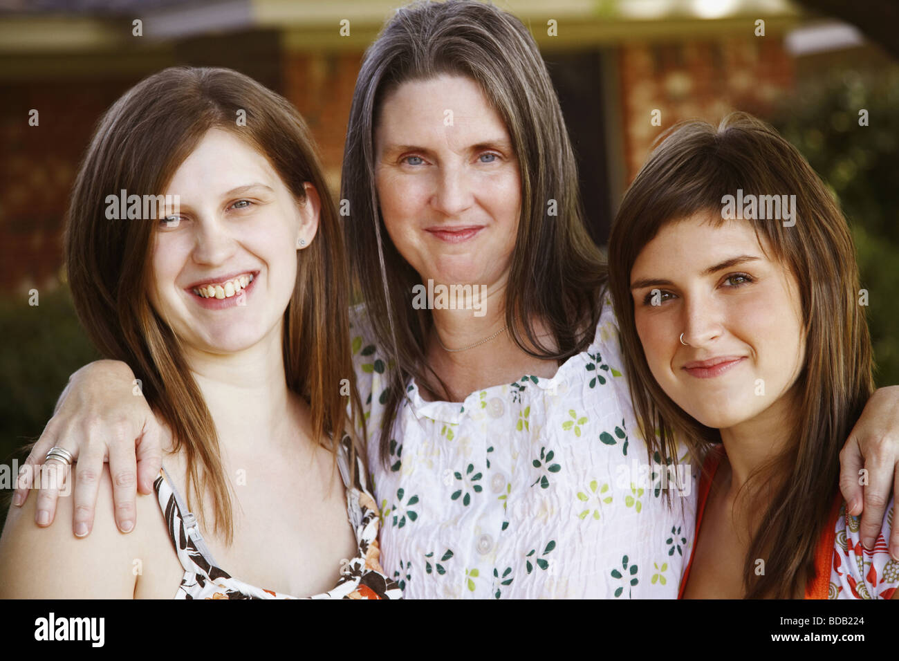 Portrait of a mature woman with her daughters smiling Stock Photo